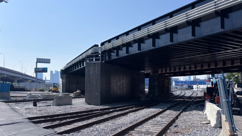 The completed High Line rail bridge carrying track over a roadway after replacement.