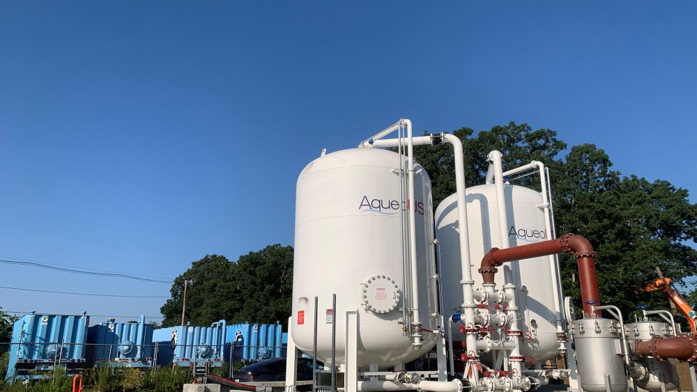 Rows of tall cylindrical treatment vessels at the University of Rhode Island interim PFAS water treatment facility.